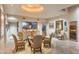 Elegant dining room featuring a glass table, comfortable seating, and built-in display cabinets at 40478 N 108Th Pl, Scottsdale, AZ 85262