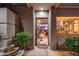 Inviting entryway with an open door, water feature, and lush plants at 40478 N 108Th Pl, Scottsdale, AZ 85262