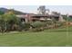 View of the rear exterior of the home with a golf course and desert landscaping at 40478 N 108Th Pl, Scottsdale, AZ 85262