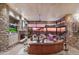 Spacious living room with stone fireplace, expansive windows, and comfortable seating arrangement at 40478 N 108Th Pl, Scottsdale, AZ 85262