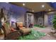 Cozy patio with wicker furniture, artistic decor, and unique green tropical rug at 40478 N 108Th Pl, Scottsdale, AZ 85262