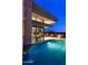 Beautiful view of a backyard swimming pool with a waterfall feature at twilight at 40478 N 108Th Pl, Scottsdale, AZ 85262