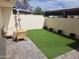 Private backyard featuring low-maintenance artificial grass, brick pavers, seating and ample space at 4304 N Parkway Ave, Scottsdale, AZ 85251