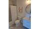 A full bathroom with white vanity, round mirror, tile shower and modern shelves provides a clean and functional space at 4304 N Parkway Ave, Scottsdale, AZ 85251