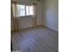 An inviting bedroom with plenty of natural light features neutral paint, wood floors and light neutral curtains at 4304 N Parkway Ave, Scottsdale, AZ 85251