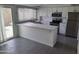 Bright kitchen featuring white cabinets, stainless steel appliances, and granite countertops at 4304 N Parkway Ave, Scottsdale, AZ 85251