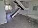 Open-concept living room with staircase and adjacent dining area, featuring tile floors at 4304 N Parkway Ave, Scottsdale, AZ 85251