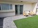 Inviting brick-paved patio with artificial grass, complete with patio furniture and sliding glass door at 4304 N Parkway Ave, Scottsdale, AZ 85251