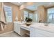 Bright bathroom with dual sinks, white cabinets, quartz countertop, large mirror, and lots of natural light at 4661 E French Rd, San Tan Valley, AZ 85143