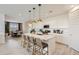 Well-lit kitchen with white cabinets, a quartz island with bar seating, and modern stainless steel appliances at 4661 E French Rd, San Tan Valley, AZ 85143