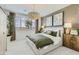 Serene main bedroom with a decorative light fixture, two abstract art pieces, and soft natural light at 4661 E French Rd, San Tan Valley, AZ 85143