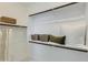 This walk-in closet features a white wall, custom shelving, and stylish baskets and throw pillows to provide a cozy space at 4661 E French Rd, San Tan Valley, AZ 85143