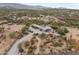 Aerial view of the home and property, showcasing the desert landscaping and extensive grounds at 49011 N 7Th Ave, New River, AZ 85087