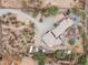 Aerial top-down view showcases the home's layout, desert landscape and unique driveway layout at 49011 N 7Th Ave, New River, AZ 85087