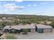 Expansive desert property showcasing a home with a large lot and garage at 49011 N 7Th Ave, New River, AZ 85087