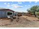 Inviting backyard sitting area with a fire pit, mature trees, and ample space for outdoor gatherings at 49011 N 7Th Ave, New River, AZ 85087