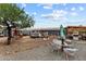 Expansive backyard with various seating areas, including covered pergolas, ideal for outdoor gatherings and relaxation at 49011 N 7Th Ave, New River, AZ 85087