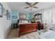 Inviting bedroom showcasing a sleigh bed, blue walls, and abundant natural light at 49011 N 7Th Ave, New River, AZ 85087