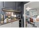 Stylish butler's pantry area with granite countertops, wine rack, and decorative lighting at 49011 N 7Th Ave, New River, AZ 85087