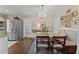 Bright dining room featuring a chandelier, stainless steel refrigerator, and comfortable seating at 49011 N 7Th Ave, New River, AZ 85087