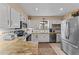 A functional kitchen with white cabinets, granite countertops, and stainless steel appliances at 49011 N 7Th Ave, New River, AZ 85087