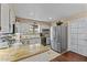 Bright kitchen with white cabinets, granite counters, and stainless steel appliances at 49011 N 7Th Ave, New River, AZ 85087
