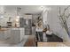 Well-lit kitchen featuring stainless steel appliances, an island, and open shelving at 49011 N 7Th Ave, New River, AZ 85087