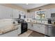 Well-lit kitchen featuring granite counters, stainless steel appliances, and tile flooring at 49011 N 7Th Ave, New River, AZ 85087