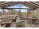 Relaxing sunroom with large windows, comfortable seating, and rustic decor overlooking mountain views at 49011 N 7Th Ave, New River, AZ 85087