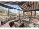 Inviting sunroom with comfortable wicker seating, dining table, and bright natural light at 49011 N 7Th Ave, New River, AZ 85087