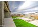 A well landscaped backyard with artificial turf, patio, and a fire feature at 5650 E Scarlet St, Mesa, AZ 85215
