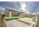 A well manicured backyard with artificial turf, desert landscaping, and patio at 5650 E Scarlet St, Mesa, AZ 85215