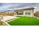 Well maintained backyard featuring a patio, artificial grass and a built-in fire feature at 5650 E Scarlet St, Mesa, AZ 85215
