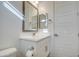 Clean bathroom with white cabinetry, a single sink, and a decorative mirror at 5650 E Scarlet St, Mesa, AZ 85215