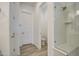 Bright bathroom showcasing a glass shower with a built-in bench and a linen closet at 5650 E Scarlet St, Mesa, AZ 85215
