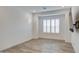 Bright bedroom with tiled flooring, a large window with shutters, and a mounted television at 5650 E Scarlet St, Mesa, AZ 85215