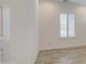 Neutral bedroom features wood-look tile flooring and a window with white shutters at 5650 E Scarlet St, Mesa, AZ 85215