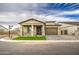Beautiful single-Gathering home with lush green lawn, stone accents, and a two-car garage at 5650 E Scarlet St, Mesa, AZ 85215