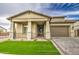 Stunning home featuring a welcoming front porch with stone accents and a well-manicured lawn at 5650 E Scarlet St, Mesa, AZ 85215