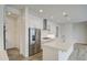 Bright kitchen with white cabinetry, a stainless steel refrigerator, and a large center island at 5650 E Scarlet St, Mesa, AZ 85215