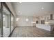 This spacious living area offers wood-look tile and access to the kitchen at 5650 E Scarlet St, Mesa, AZ 85215