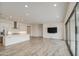 Open concept living area showcases the kitchen, wood-look tile flooring, and a large window at 5650 E Scarlet St, Mesa, AZ 85215