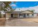 Charming single-story home featuring neutral paint, desert landscaping, and a covered front porch at 6265 W Mariposa St, Phoenix, AZ 85033