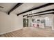 Spacious living room featuring hardwood floors and a modern kitchen with stainless steel appliances at 6265 W Mariposa St, Phoenix, AZ 85033