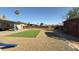 Expansive backyard with artificial turf, gravel, storage shed, and covered patio, ideal for relaxation and entertainment at 7217 W Claremont St, Glendale, AZ 85303