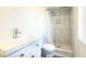 Modern bathroom with white vanity, toilet, walk-in shower featuring marble tile and stylish fixtures at 7217 W Claremont St, Glendale, AZ 85303