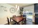 Bright dining area features a modern light fixture and access to the backyard patio through sliding glass doors at 7217 W Claremont St, Glendale, AZ 85303