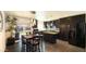 Modern kitchen features dark cabinetry, stainless steel appliances, island, and eat-in dining space overlooking the backyard at 7217 W Claremont St, Glendale, AZ 85303