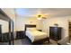 Elegant main bedroom with dark furniture, plush bedding, ceiling fan, and closet providing a comfortable retreat at 7217 W Claremont St, Glendale, AZ 85303