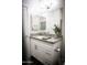 Bathroom with gray granite vanity top, white cabinets and drawers, and stainless steel fixtures at 7531 E Billings St # 132, Mesa, AZ 85207